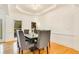 Elegant dining room with tray ceiling, chandelier, and seating for eight at 1408 Aramore Dr, Conyers, GA 30013