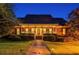 Charming single-story brick home featuring a welcoming front porch, manicured lawn, and lush landscaping at 1408 Aramore Dr, Conyers, GA 30013