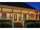 Welcoming front porch featuring a decorative front door, a covered porch, and well-maintained landscaping at 1408 Aramore Dr, Conyers, GA 30013