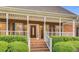 Brick home with a welcoming front porch and manicured landscaping at 1408 Aramore Dr, Conyers, GA 30013
