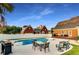 Backyard pool featuring an outdoor kitchen, dining area, and lounging chairs, perfect for gatherings at 1408 Aramore Dr, Conyers, GA 30013