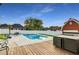 Backyard oasis with in-ground pool, wooden deck, and outdoor seating at 1408 Aramore Dr, Conyers, GA 30013