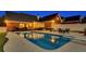 Stunning backyard pool with outdoor dining and deck seating at dusk for relaxation and entertainment at 1408 Aramore Dr, Conyers, GA 30013