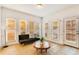 Sunroom featuring hardwood floors and several windows for natural light at 1408 Aramore Dr, Conyers, GA 30013