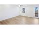 A bedroom with wood floor, a ceiling fan, a window, and a door to a balcony at 3900 Allegretto Cir # 51, Atlanta, GA 30339