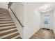 Bright foyer featuring hardwood floors, staircase with wooden handrail, and a glass-paneled front door at 3900 Allegretto Cir # 51, Atlanta, GA 30339
