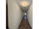 Long hallway with hardwood floors leading into an open-concept living space at 3900 Allegretto Cir # 51, Atlanta, GA 30339