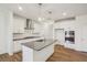 Modern kitchen featuring white cabinets, gray countertops, stainless appliances, and a central island sink at 3900 Allegretto Cir # 51, Atlanta, GA 30339
