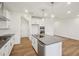 Well-lit kitchen with white cabinetry, stainless steel appliances, gray countertops, and wood laminate flooring at 3900 Allegretto Cir # 51, Atlanta, GA 30339