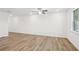 Spacious room with wood floors, a ceiling fan, natural light from a window, and neutral paint at 3900 Allegretto Cir # 51, Atlanta, GA 30339