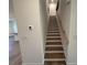 A staircase with wood treads and white risers, complemented by a natural wood handrail at 3900 Allegretto Cir # 51, Atlanta, GA 30339