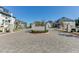 A well-maintained street and entrance to the community with lush landscaping and upscale residences at 3900 Allegretto Cir # 51, Atlanta, GA 30339