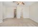 Spacious bedroom with neutral carpet, ceiling fan, and multiple doorways for easy access at 4273 High Park Ln # 15, Atlanta, GA 30344