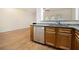 Stylish kitchen with stainless steel dishwasher, granite counters, and view to the living room at 4273 High Park Ln # 15, Atlanta, GA 30344