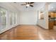 Open-concept living room with hardwood floors, ceiling fan, and seamless flow to the kitchen at 4273 High Park Ln # 15, Atlanta, GA 30344