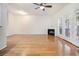 Bright and airy living room with hardwood floors, ceiling fan, and a cozy fireplace at 4273 High Park Ln # 15, Atlanta, GA 30344