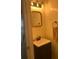 Bathroom featuring a vanity with sink and a mirror, complemented by warm lighting at 222 Waterford Cove Dr, Suwanee, GA 30024