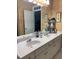 Bathroom featuring double vanity with white countertop and cabinets plus neutral wallpaper at 222 Waterford Cove Dr, Suwanee, GA 30024