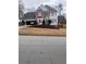 Traditional two-story home with a well-manicured lawn, a two-car garage, and a symmetrical facade at 222 Waterford Cove Dr, Suwanee, GA 30024