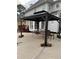 Backyard gazebo with table and chairs near a covered swimming pool for outdoor relaxation at 222 Waterford Cove Dr, Suwanee, GA 30024