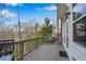 Back deck provides a serene view of the surrounding trees and outdoor lounging and dining space at 2318 Willington Shoals Se Pl, Smyrna, GA 30080