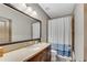 Bathroom with a large vanity, ample lighting, and a shower with a blue and white striped shower curtain at 2318 Willington Shoals Se Pl, Smyrna, GA 30080
