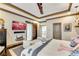 Spacious bedroom with hardwood floors, tray ceilings, barn door, and a wall-mounted TV for entertainment at 2318 Willington Shoals Se Pl, Smyrna, GA 30080