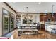 Sun-filled dining area features an industrial chandelier, seating for six, and access to the back deck at 2318 Willington Shoals Se Pl, Smyrna, GA 30080