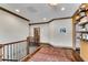 Upstairs landing with wooden floors, art, shelves, and trim provides transition between living spaces at 2318 Willington Shoals Se Pl, Smyrna, GA 30080