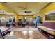Bright home gym featuring wood floors, a mirrored wall, ceiling fan, and an array of workout equipment at 2318 Willington Shoals Se Pl, Smyrna, GA 30080