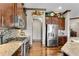 Modern kitchen with stainless steel appliances, dark wood cabinetry, and stone countertops at 2318 Willington Shoals Se Pl, Smyrna, GA 30080