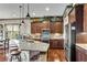 Gourmet kitchen with dark wood cabinetry, stainless appliances, and granite countertops at 2318 Willington Shoals Se Pl, Smyrna, GA 30080
