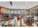 Open living area features a stone fireplace, hardwood floors, and natural light from many windows at 2318 Willington Shoals Se Pl, Smyrna, GA 30080