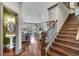 Open-concept living space featuring hardwood floors, natural light, and a staircase at 2318 Willington Shoals Se Pl, Smyrna, GA 30080