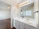 Bathroom featuring double sinks, a large mirror, and a view into an adjoining bedroom at 3165 Bellestone Ct, Marietta, GA 30066