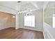 Sunlit dining room with hardwood floors, modern lighting, wainscoting, and bright natural light at 3165 Bellestone Ct, Marietta, GA 30066