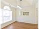 Bright dining room with wainscoting, wood floors, a modern light fixture and a large window at 3165 Bellestone Ct, Marietta, GA 30066