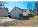 Picture showcasing the side of the home with a two-car garage and tidy landscaping on a sunny day at 3165 Bellestone Ct, Marietta, GA 30066