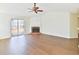 Spacious living room with hardwood floors, a brick fireplace, and sliding glass doors to the backyard at 3165 Bellestone Ct, Marietta, GA 30066
