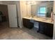 Spacious bathroom with dual sinks, ample counter space, and a large mirror over dark wood cabinets at 3831 Village Crossing Ln, Ellenwood, GA 30294