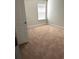 Neutral bedroom with a window and a carpeted floor that provides a comfortable and calm atmosphere at 3831 Village Crossing Ln, Ellenwood, GA 30294
