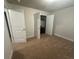 Bright bedroom with double closets, soft carpet, and freshly painted walls, ready for personalization at 3831 Village Crossing Ln, Ellenwood, GA 30294