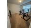 Workout bedroom with weightlifting equipment in a neutral room with a carpeted floor and a window at 3831 Village Crossing Ln, Ellenwood, GA 30294