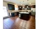 Modern kitchen with stainless steel appliances, dark cabinetry, hardwood floors, and a center island at 3831 Village Crossing Ln, Ellenwood, GA 30294