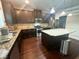 Contemporary kitchen features stainless appliances, granite counters, a central island, and dark cabinets at 3831 Village Crossing Ln, Ellenwood, GA 30294