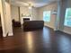 Spacious living room with hardwood floors, a fireplace, and comfortable seating, great for entertaining at 3831 Village Crossing Ln, Ellenwood, GA 30294