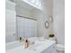 Bathroom with white vanity, white tile, and a shower with white curtain at 1640 Racquet Club Cir, Lawrenceville, GA 30043