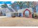 Beautiful single-story home with a two-car garage, large window, and brick accents at 1640 Racquet Club Cir, Lawrenceville, GA 30043