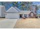 Charming single-story home with a well-manicured lawn and attached two-car garage at 1640 Racquet Club Cir, Lawrenceville, GA 30043