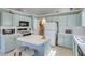 Clean kitchen with island, light blue cabinetry, and modern appliances at 1640 Racquet Club Cir, Lawrenceville, GA 30043